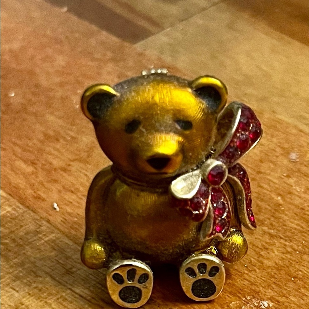 Vintage Monet teddy bear brooch with a red crystal bow and gold-tone enamel